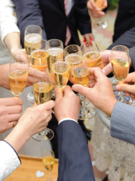 guests clanging glasses at a wedding party
