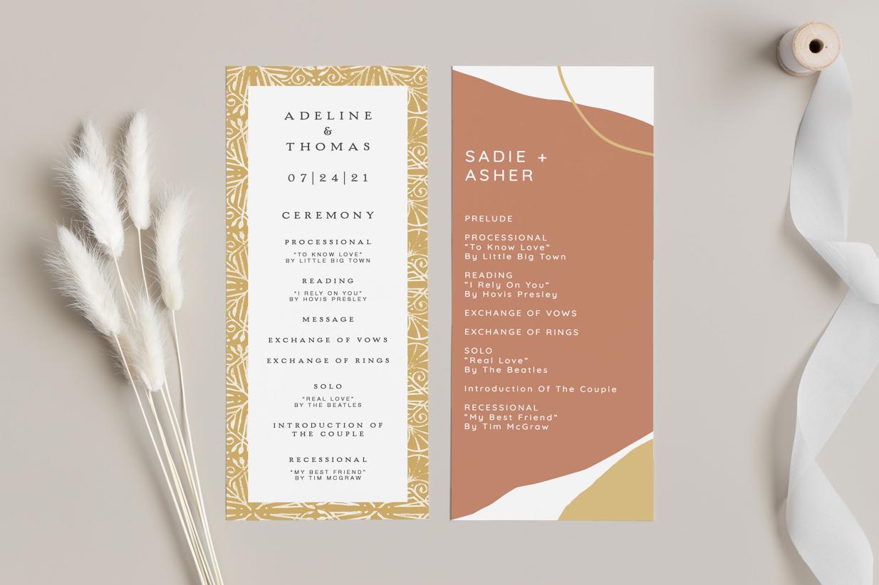 creative wedding programs sitting on table with feathers and ribbon