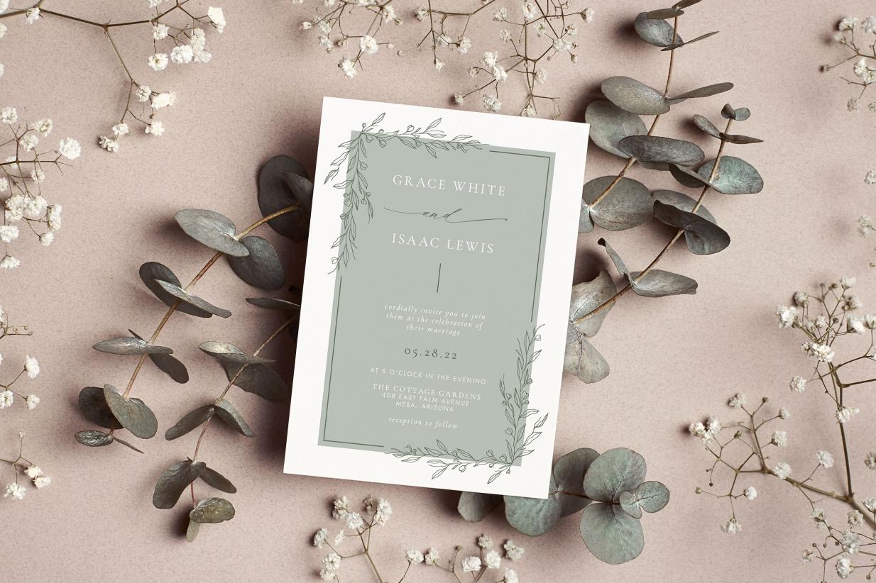 elegant wedding invitation sitting on a table decorated with babies breath