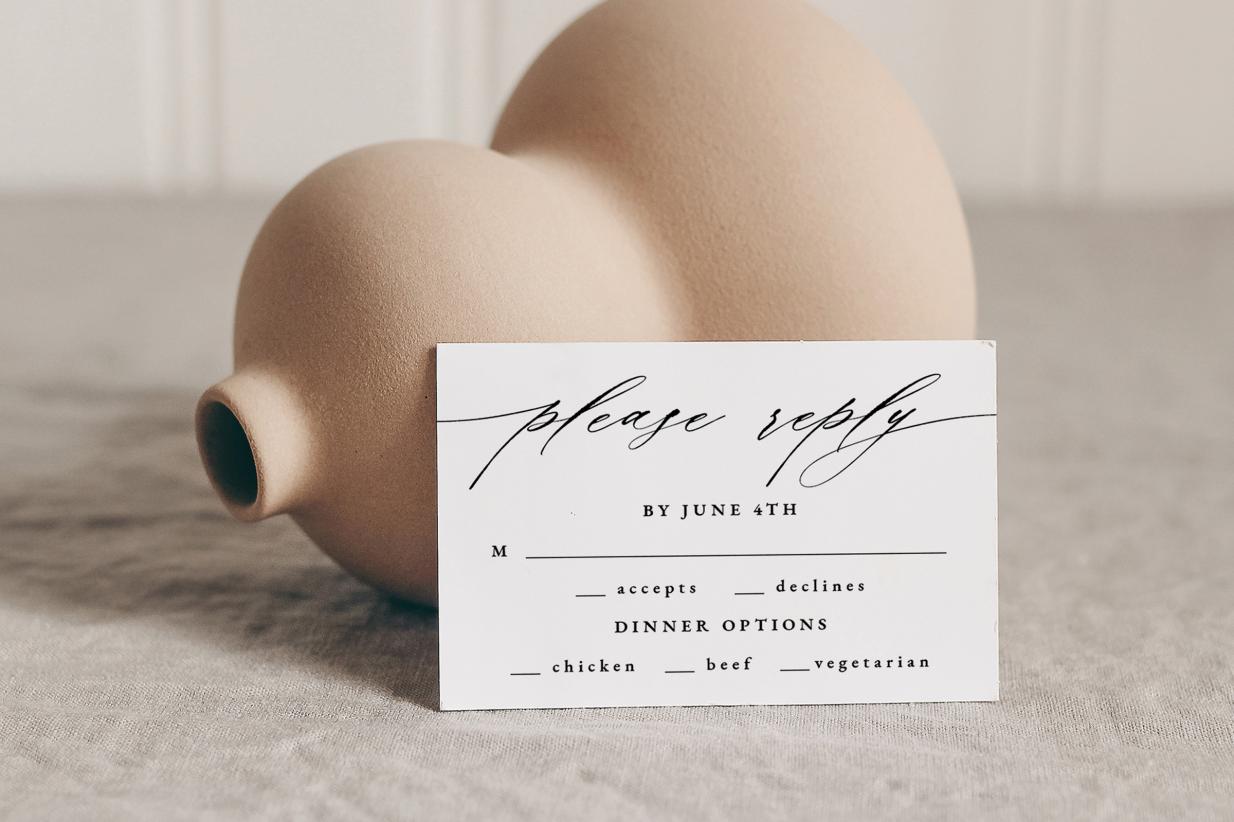 Polite RSVP reminders Reply Card next to a tan vase