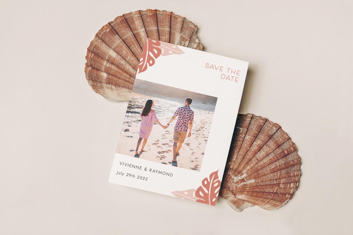 Beachy save the date on top of seashells