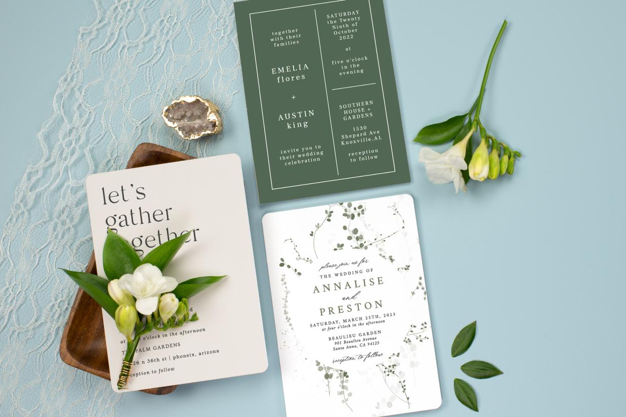 Three Flat Wedding Invitations on blue background by flowers