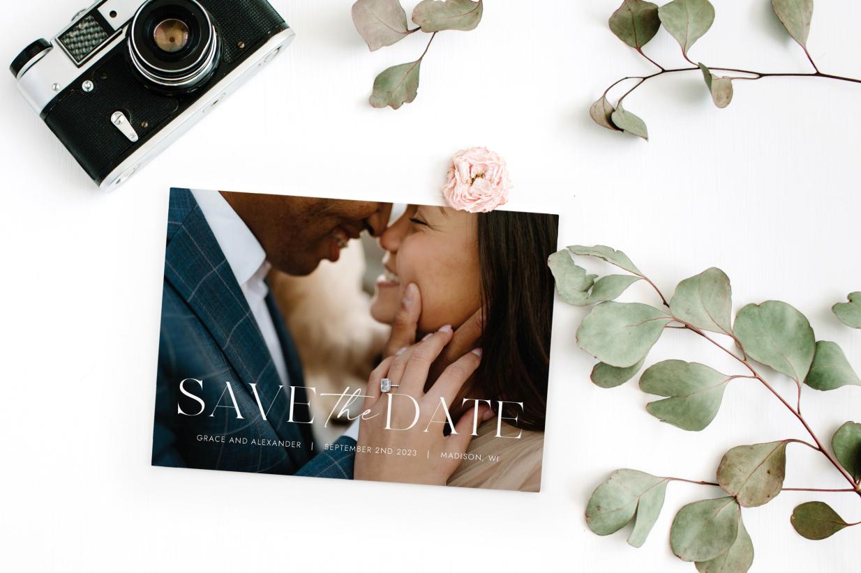 Photo Save the Date with camera and green leaves