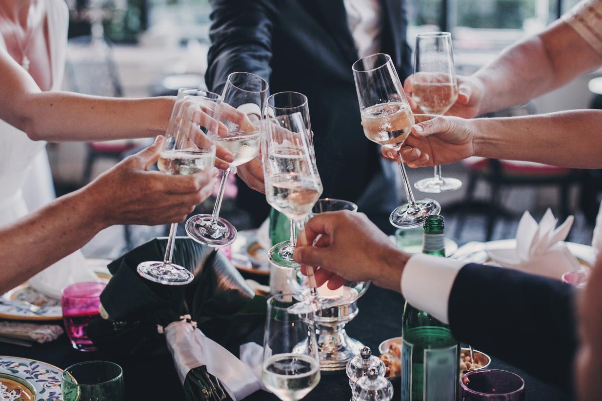 Rehearsal Dinner party clinking glasses to a toast