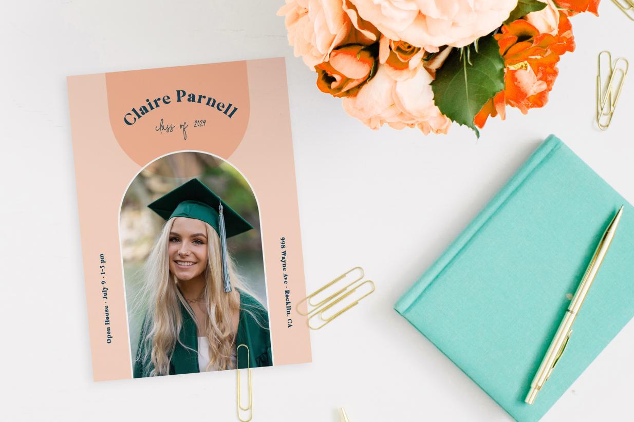 Graduation Announcement with pretty flowers on desk