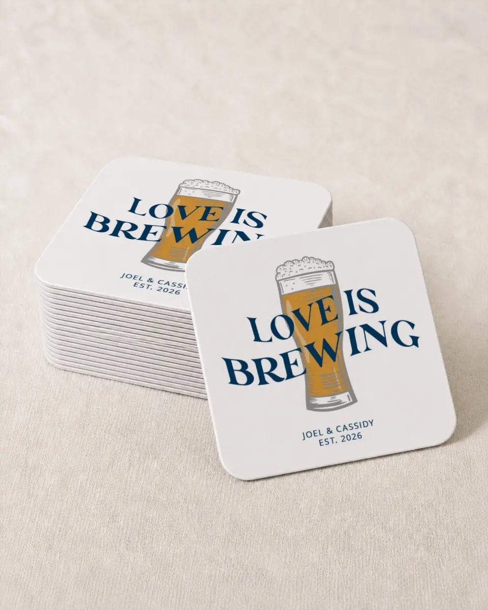 This is a 4" x 4" Wedding Coaster called Love is Brewing printed in full color with Rose Gold foil on Kraft Chipboard paper