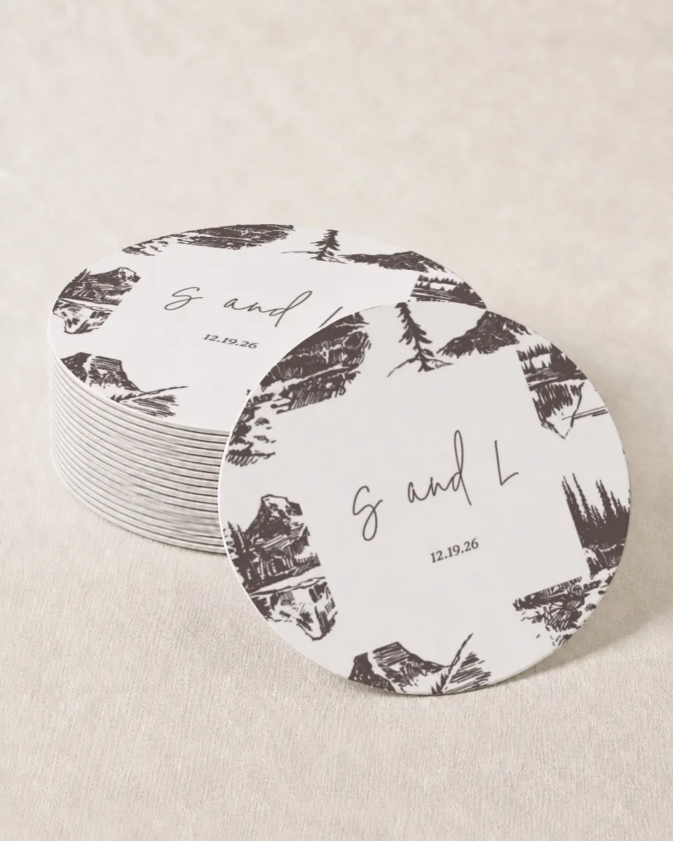 This is a 4" x 4" Wedding Coaster called Mountain Bliss printed in full color with Gold foil on Kraft Chipboard paper
