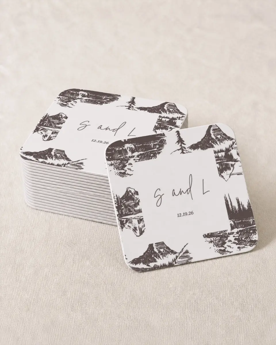 This is a 4" x 4" Wedding Coaster called Mountain Bliss printed in full color with Gold foil on Kraft Chipboard paper
