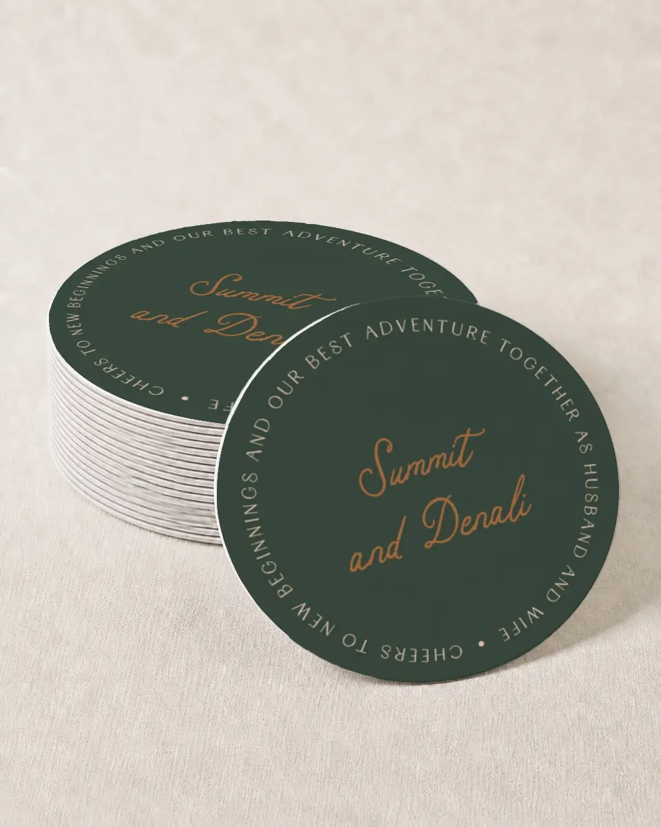 This is a 4" x 4" Wedding Coaster called Elevated Adventures printed in full color with Gold foil on Kraft Chipboard paper