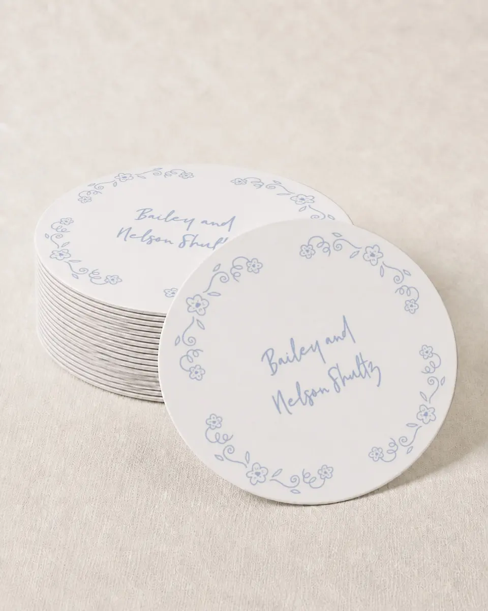 This is a 4" x 4" Wedding Coaster called Framed in Flowers printed in full color with Gold foil on Kraft Chipboard paper