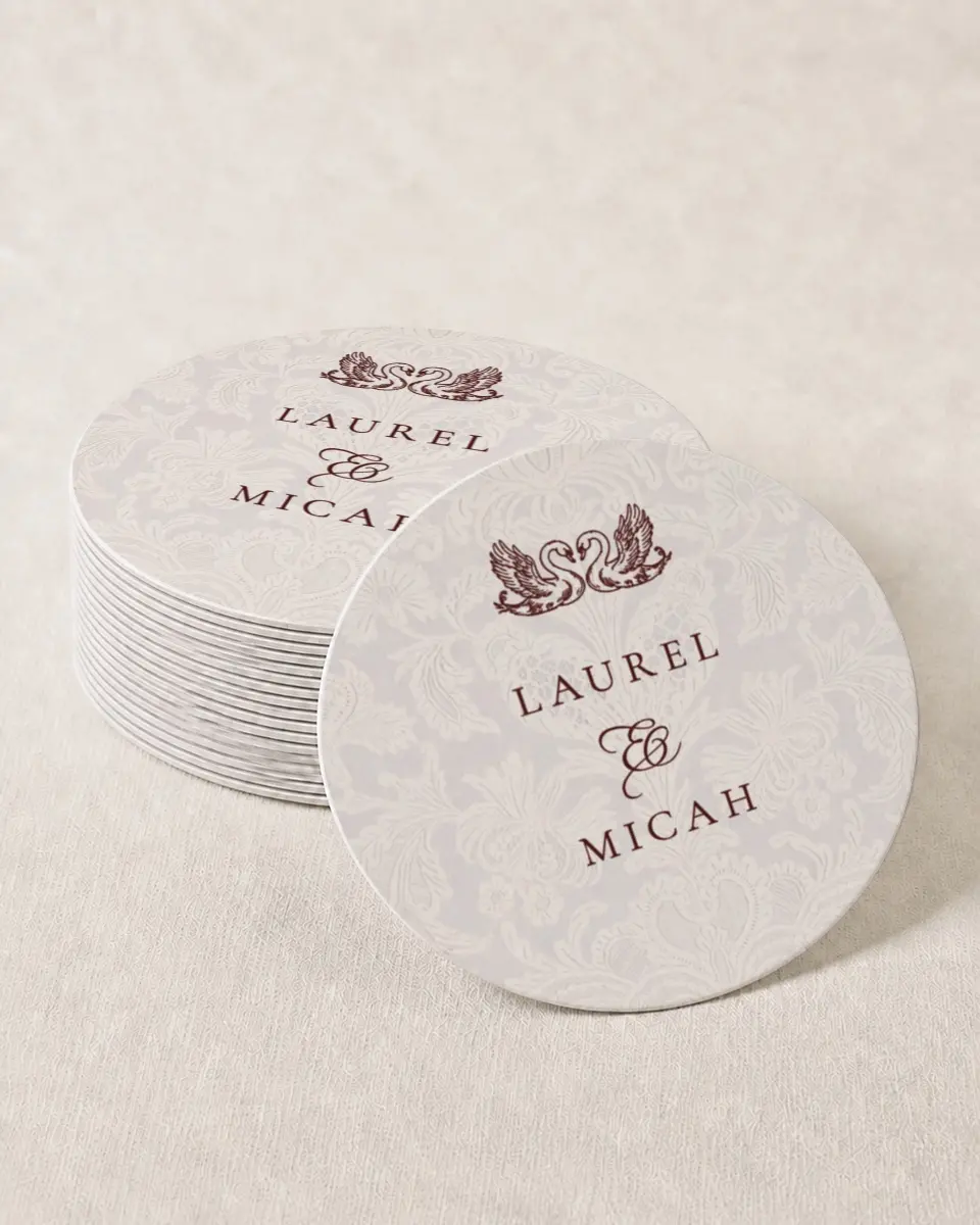 This is a 4" x 4" Wedding Coaster called Swan Song printed in full color with Rose Gold foil on Kraft Chipboard paper