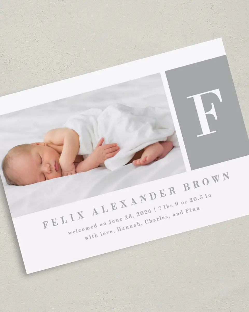 This is a 5" x 7" Birth Announcement Card called Minimal Monogram printed in full color with Silver foil on Luxe Satin (coated) paper