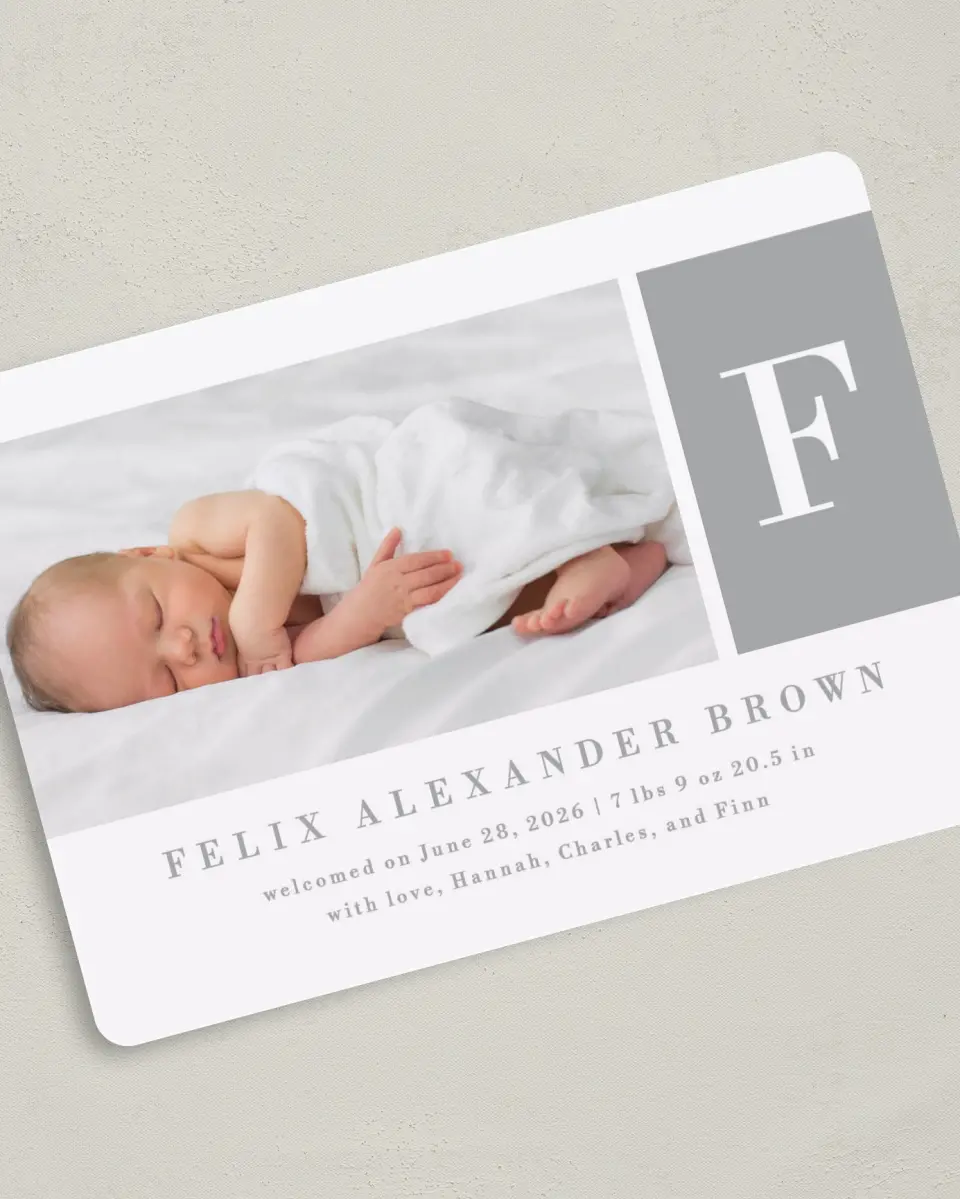 This is a 5" x 7" Birth Announcement Card called Minimal Monogram printed in full color with Silver foil on Luxe Satin (coated) paper