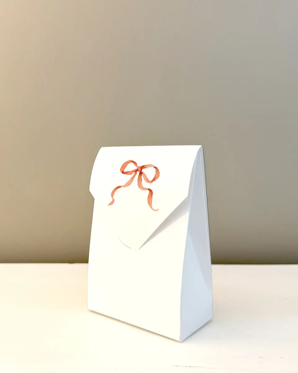 This is a 3.5" x 5.5" Wedding Favor Boxe called Festive Trimmings printed in full color with Rose Gold foil
