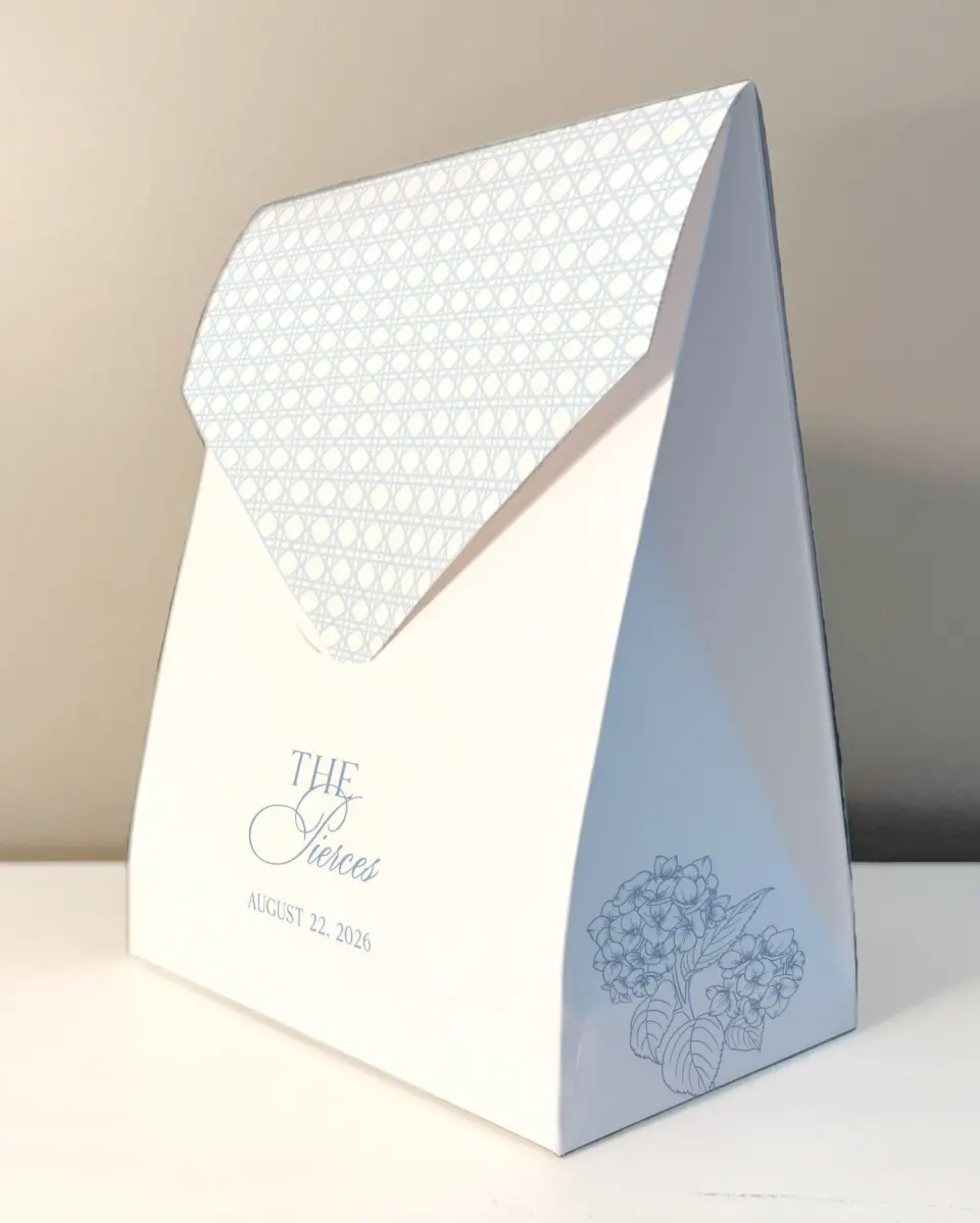This is a 6.5" x 9" Wedding Favor Boxe called Woven Serenity printed in full color with Rose Gold foil