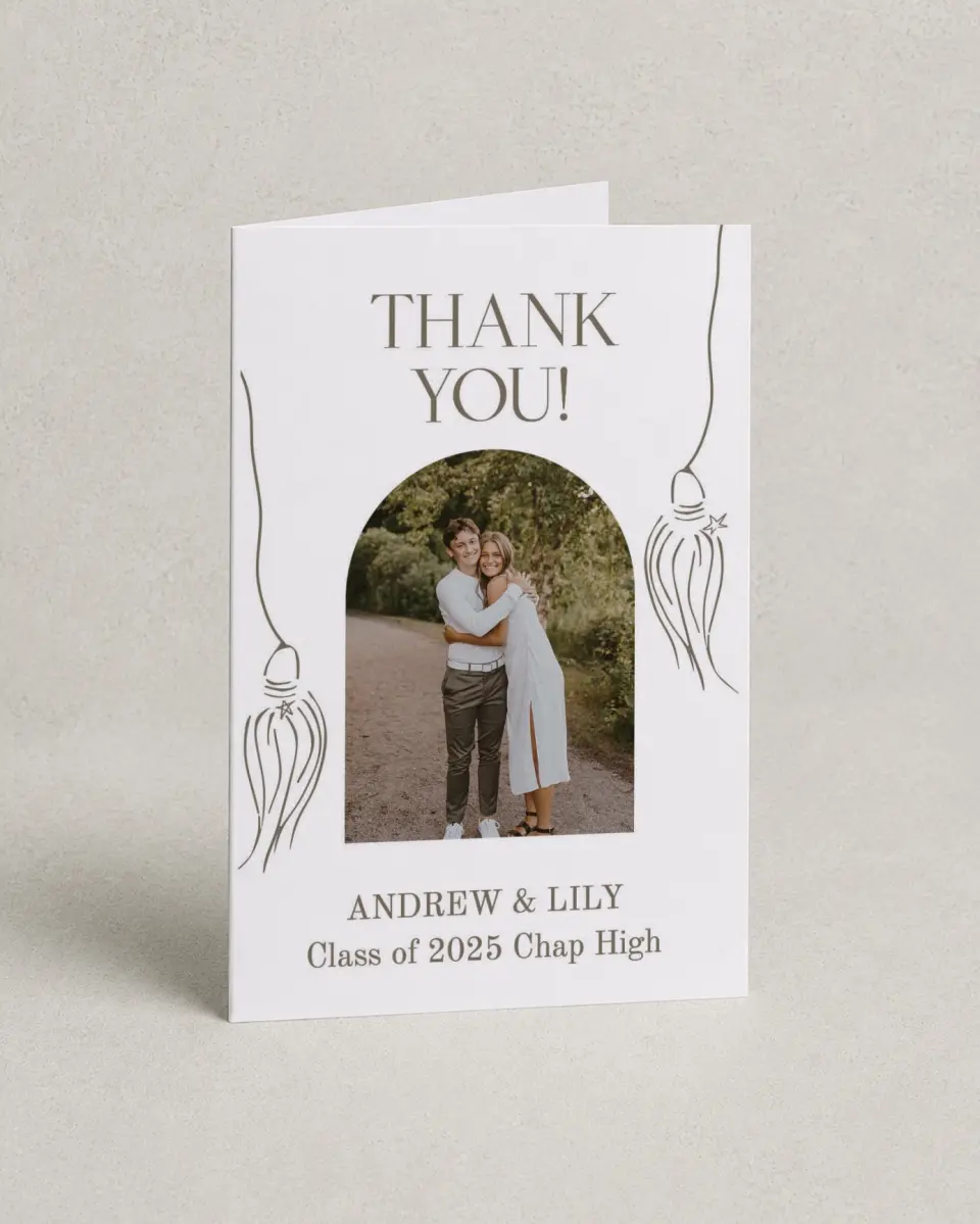 This is a 4" x 6" Folded Graduation Thank You Card called Cap and Gown printed in full color with Rose Gold foil on Luxe Satin (coated) paper