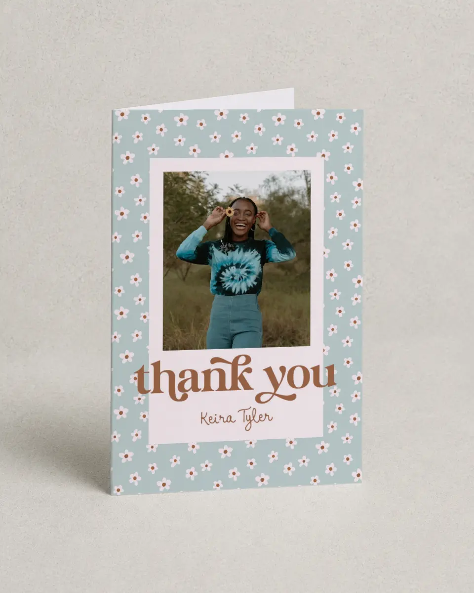 This is a 4" x 6" Folded Graduation Thank You Card called Demure Daisies printed in full color on Premium Smooth paper