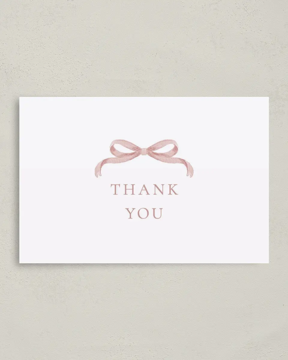 This is a 4" x 6" Folded Baby Shower Thank You Card called Bitty Bow printed in full color with Rose Gold foil on Luxe Satin (coated) paper