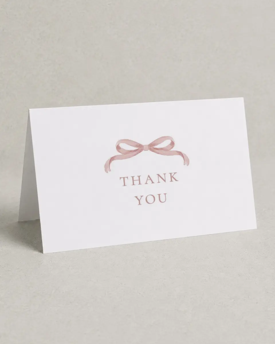 This is a 4" x 6" Folded Baby Shower Thank You Card called Bitty Bow printed in full color with Gold foil on Luxe Satin (coated) paper