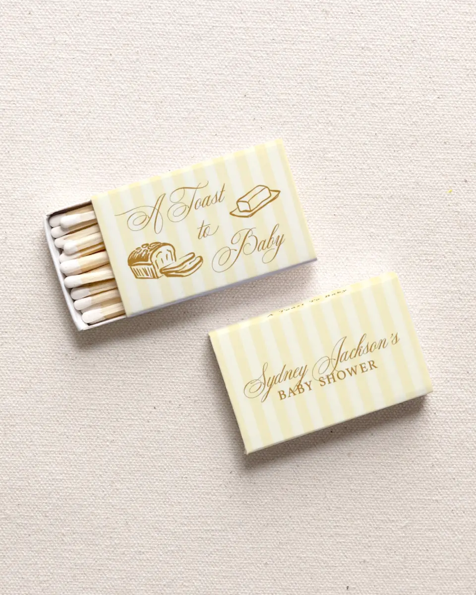 This is a 2.25" x 1.409" x .4" Wedding Matche called Toast to Baby printed in full color with Gold foil