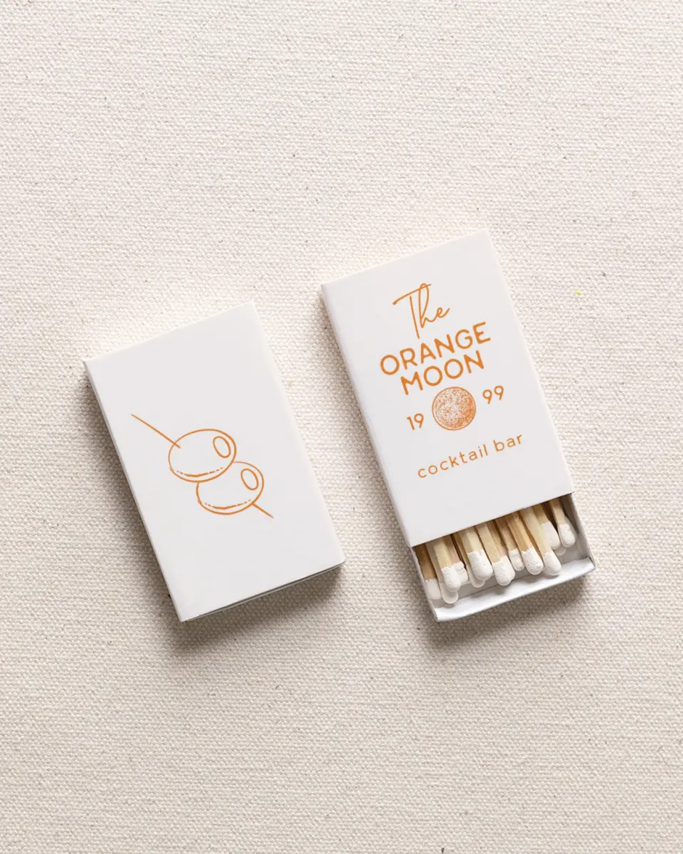 This is a 2.25" x 1.409" x .4" Business Matche called The Orange Moon printed in full color with Rose Gold foil