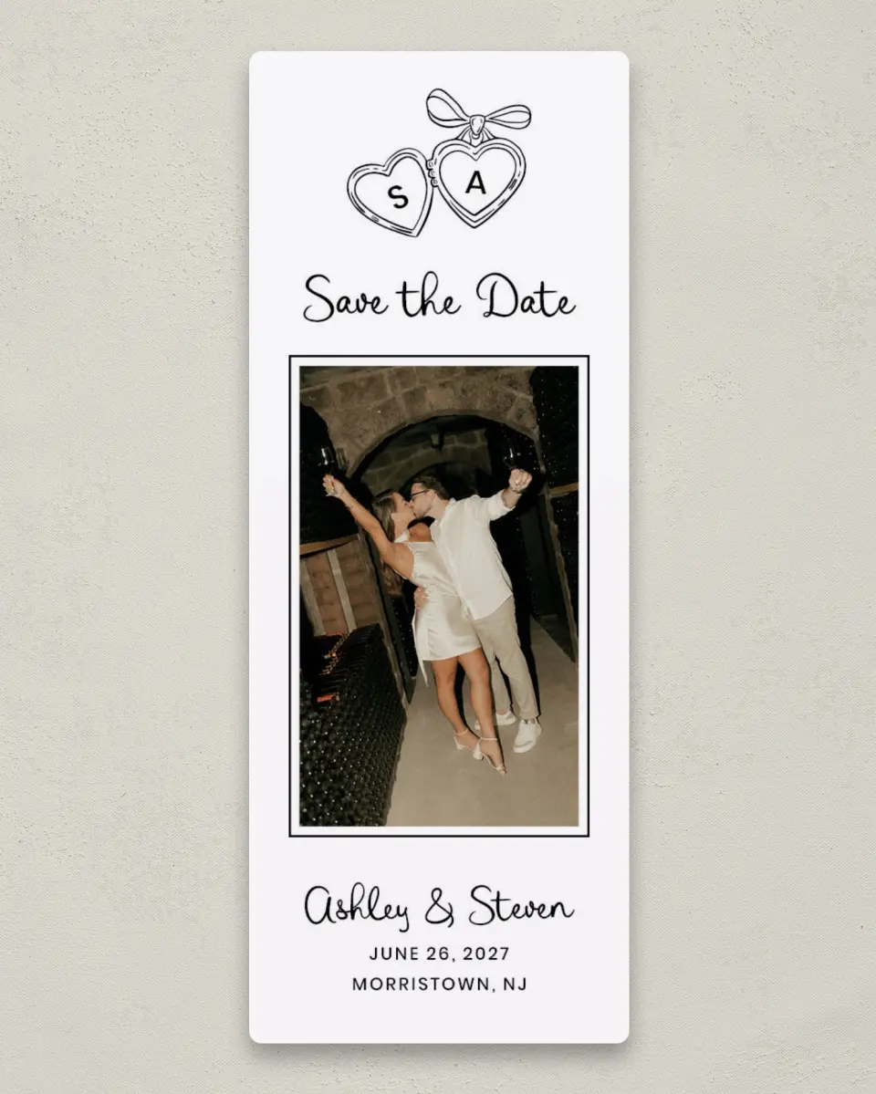 This is a 2¼" x 5⅞" Save the Date Magnet called Heart Locket printed in full color with Silver foil and a Luxe Satin finish