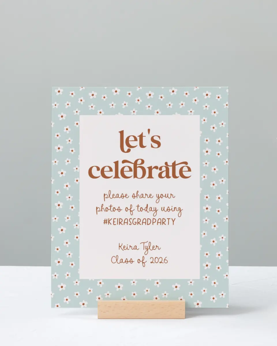 This is a 8" x 10" Let's Celebrate & Snap a Photo Grad Sign called Demure Daisies printed in full color