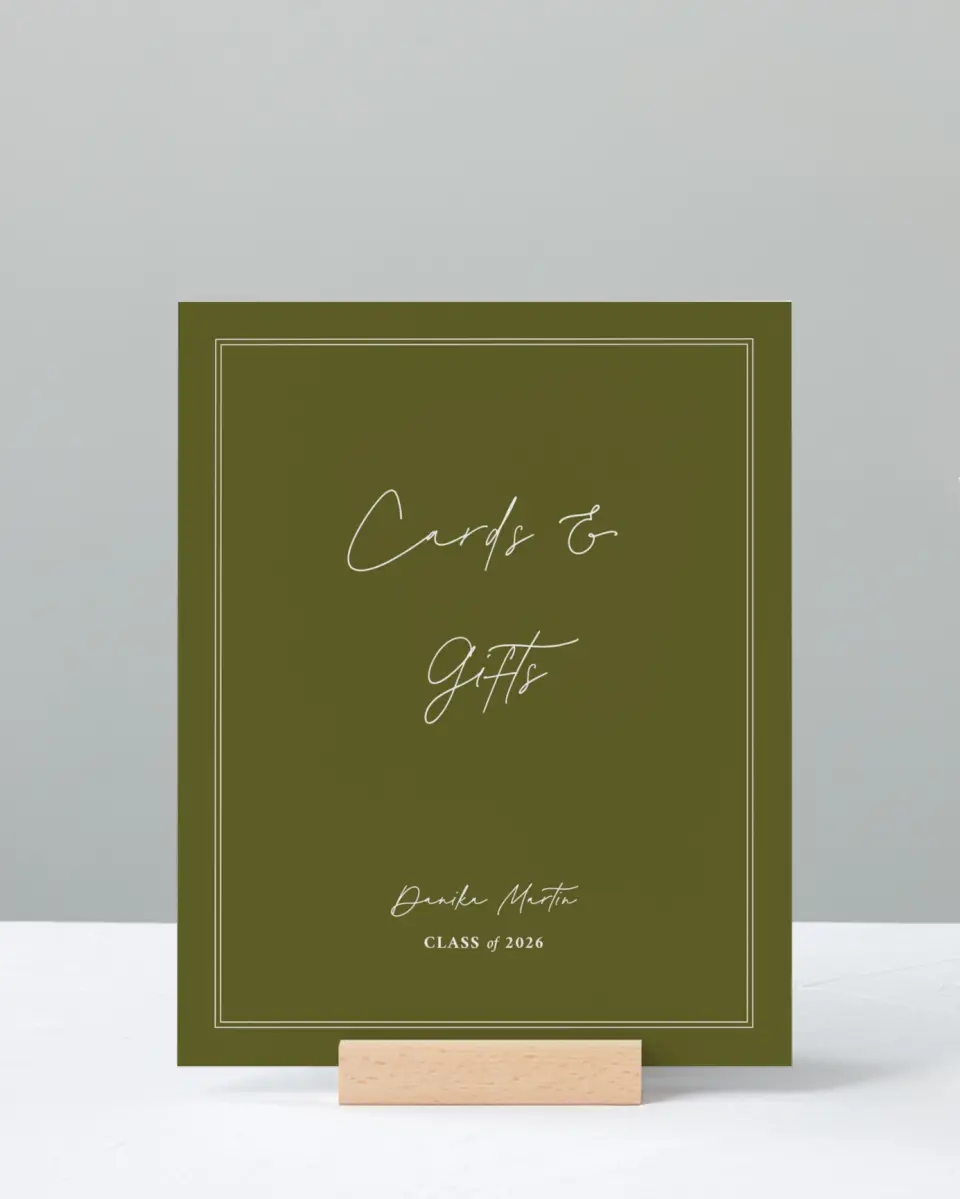 This is a 8" x 10" Cards & Gifts Grad Sign called Monumental Moment printed in full color with Rose Gold foil