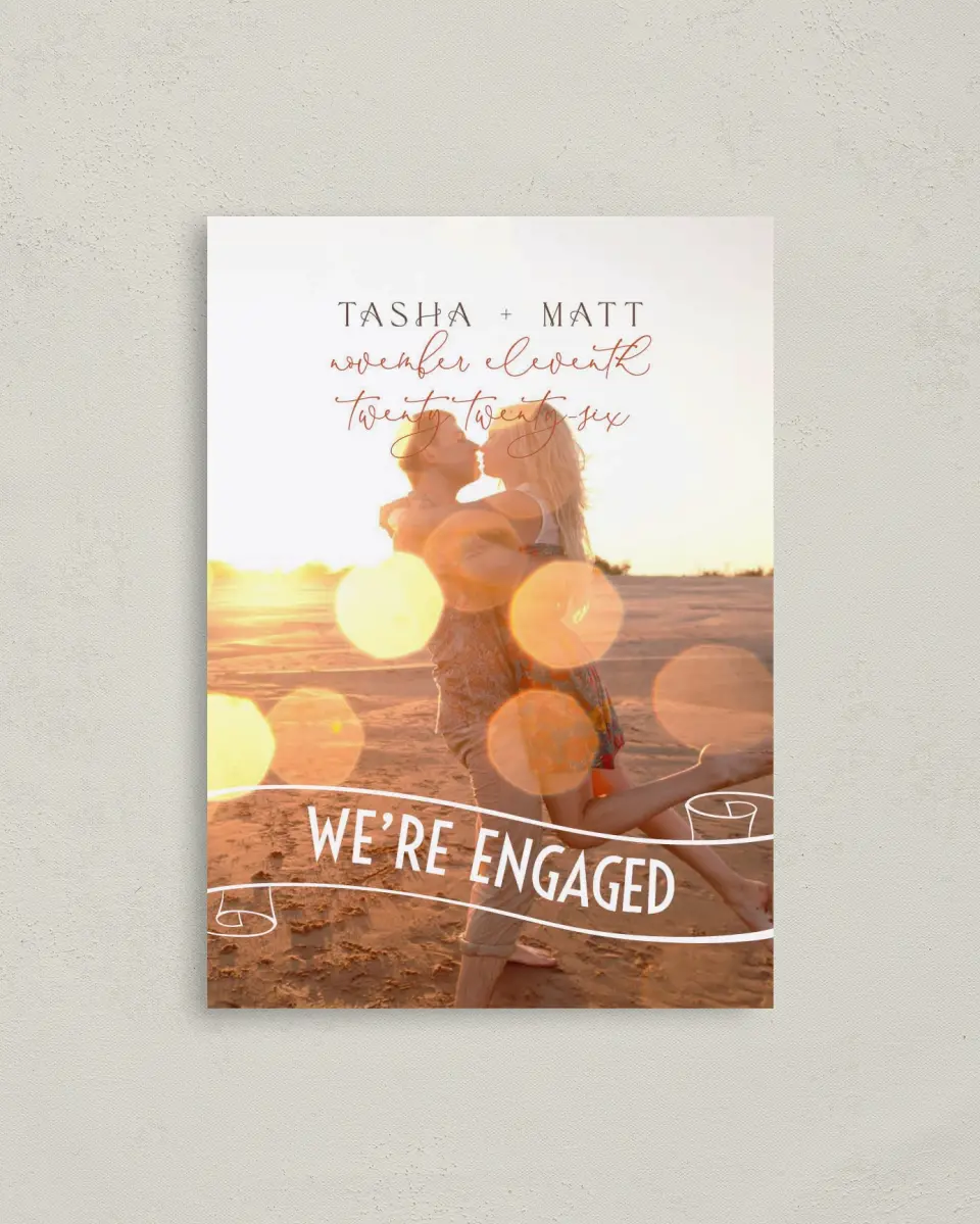 This is a 4" x 5.6" Save the Date Postcard called A Charmed Engagement printed in full color on Soft Touch Finish paper