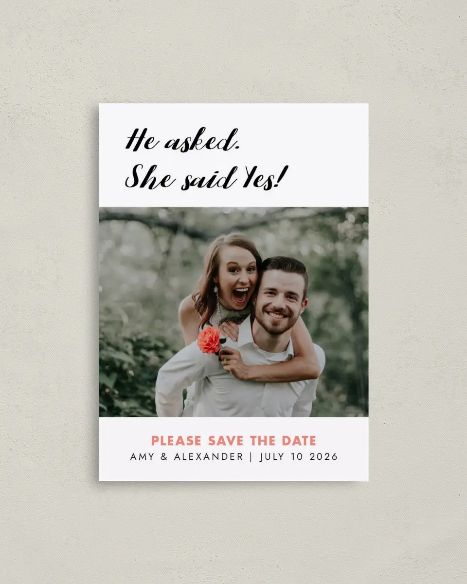This is a 4" x 5.6" Save the Date Postcard called He Asked printed in full color with Rose Gold foil on Soft Touch Finish paper