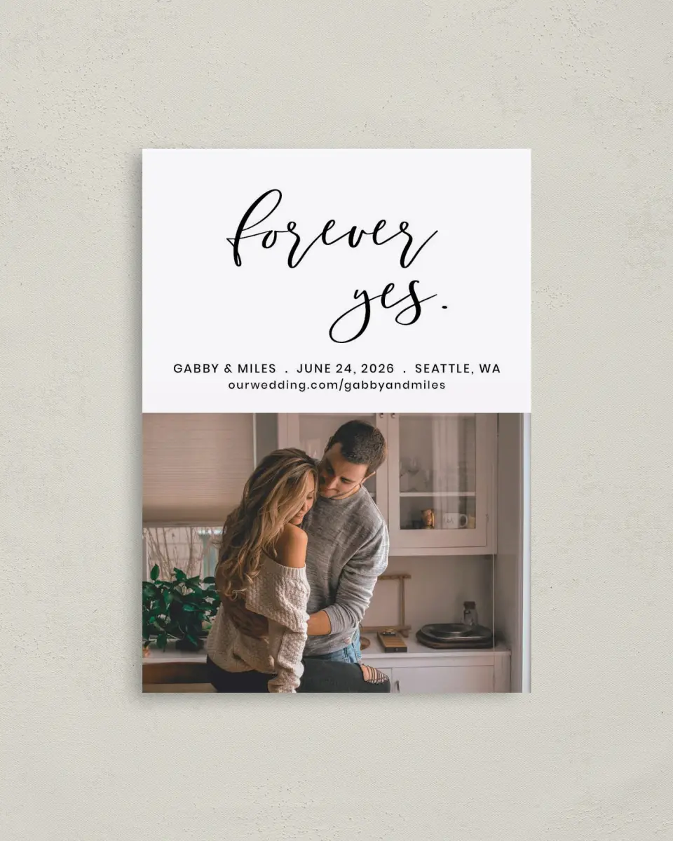 This is a 4" x 5.6" Save the Date Postcard called Forever Yes printed in full color with Rose Gold foil on Soft Touch Finish paper