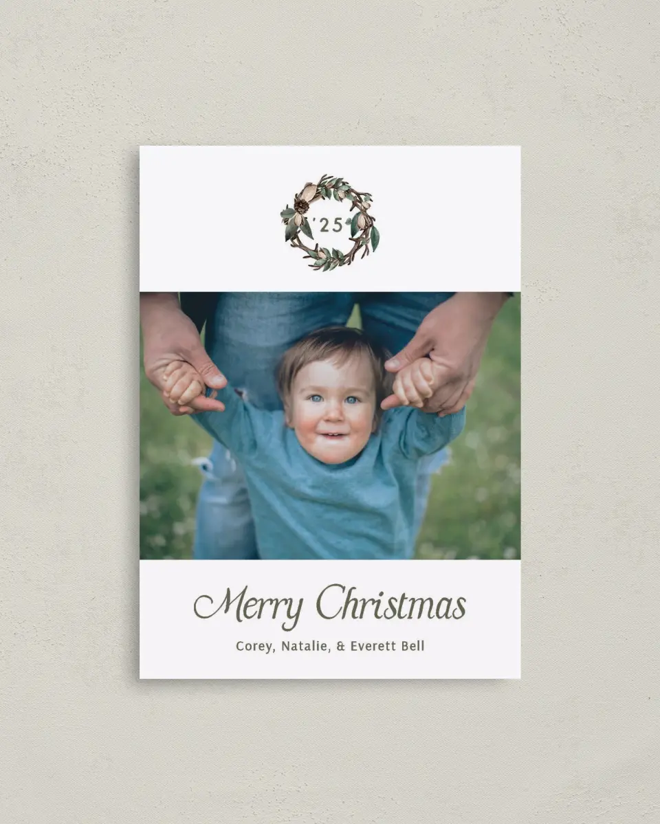 This is a 4" x 5.6" Christmas Card called Antler Wreath printed in full color with Silver foil on Soft Suede (coated) paper
