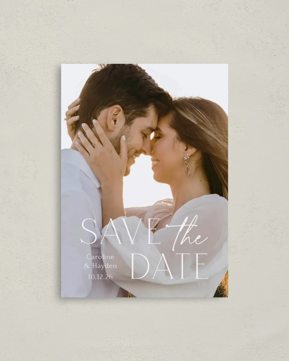 This is a 4" x 5.6" Save the Date Postcard called The Caroline printed in full color with Rose Gold foil on Soft Touch Finish paper