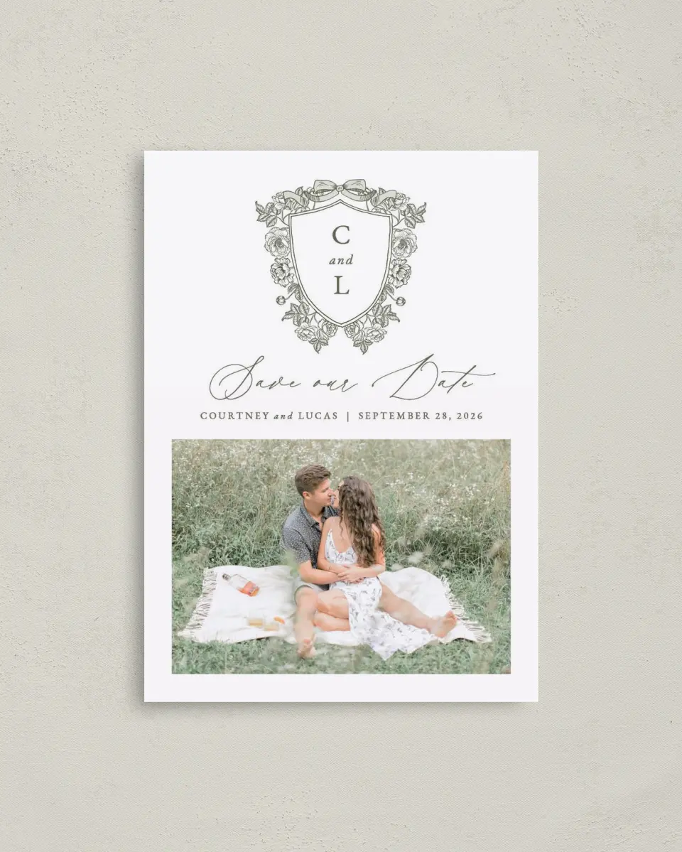 This is a 4" x 5.6" Save the Date Postcard called Elegant Crest printed in full color with Rose Gold foil on Soft Touch Finish paper