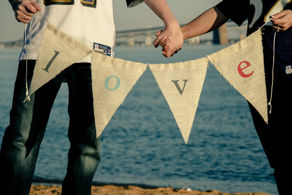 Using a burlap DIY wedding banner sign in beach engagement photos
