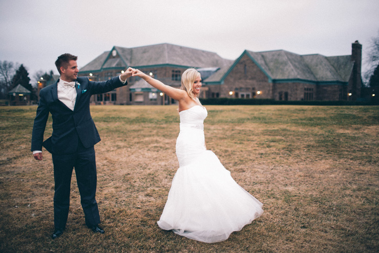 bride and groom dancing outside reception venue